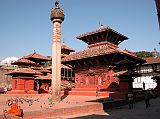 Manaslu 00 14 Kathmandu Durbar Square Jagannath Temple and King Malla Column Pigeons fly around the three-tiered, two-storied Jagannath Temple, built in the 16C. Exquisite wood-carvings embellish the doors, windows and roof struts, depicting Hindu gods. Erected in 1670, King Pratapa Malla's column stands to the left of Jagannath temple. The king sits on a lion throne atop the lotus-shaped capital, his two wives one on either side. The King's five sons also appear, one at each corner and the fifth, the youngest son, in front.